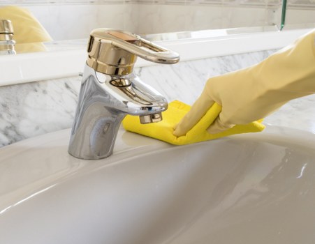 Carpet cleaning technician managing hoses and wet-floor hazards